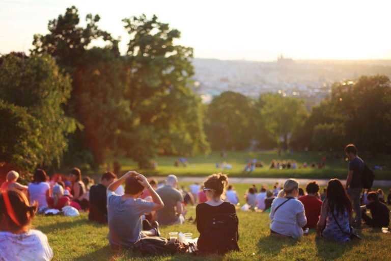 Markets Finish Only Slightly Negative After Being Hit With Worst Day of 2019 A crowd of people sitting in a park