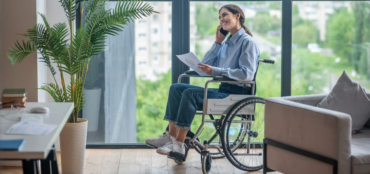 a person in a wheelchair talking on a cell phone