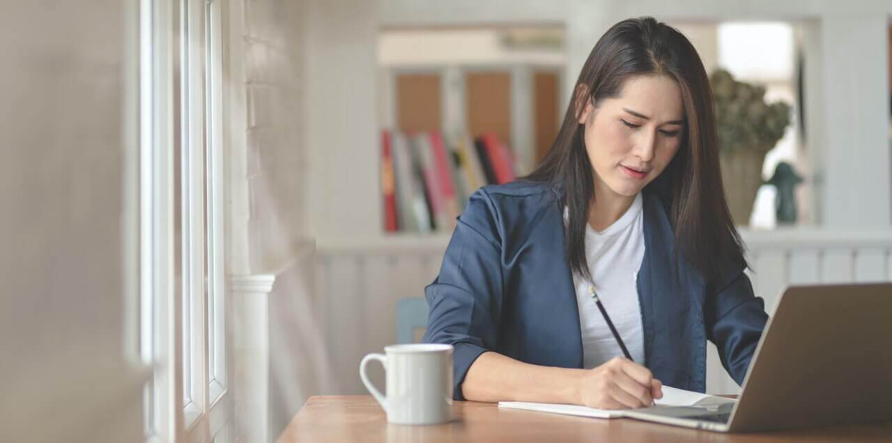 woman-in-blue-jacket-sitting-on-chair-3740558