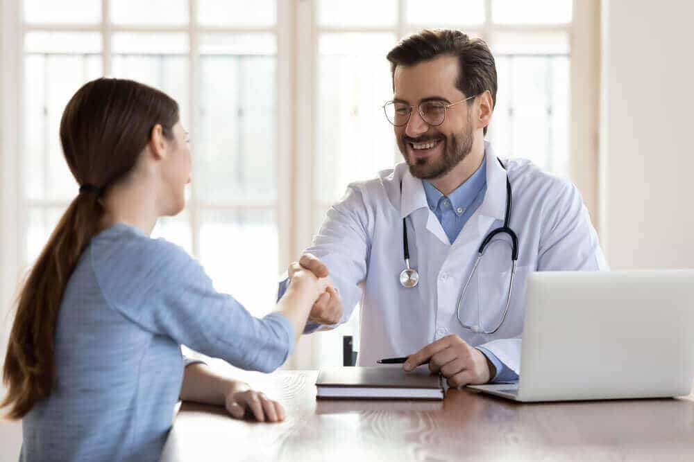 happy physician greeting patient