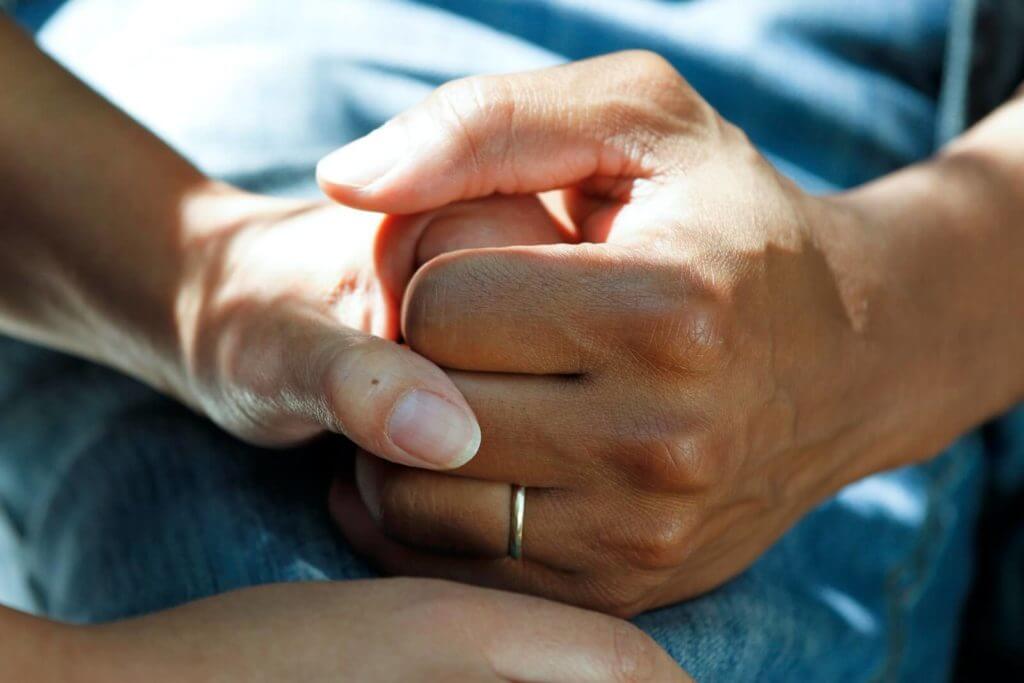 Close-up shot of interlocked hands