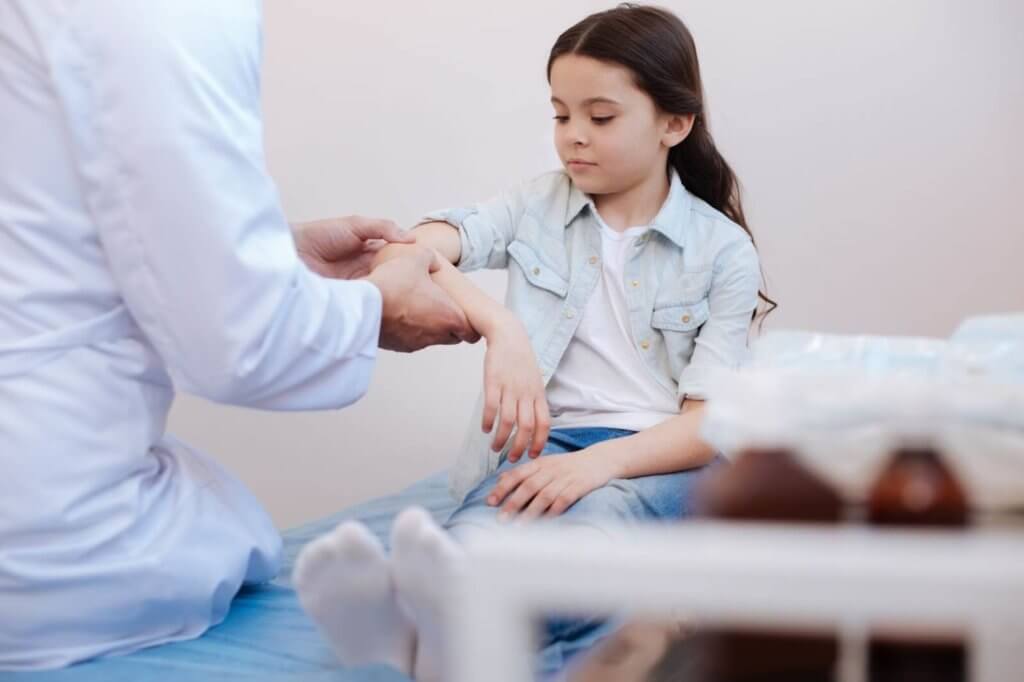 Young girl being treated by rheumatologist