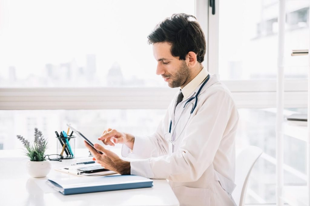 Doctor using tablet computer