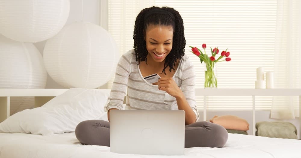 Happy black woman online shopping