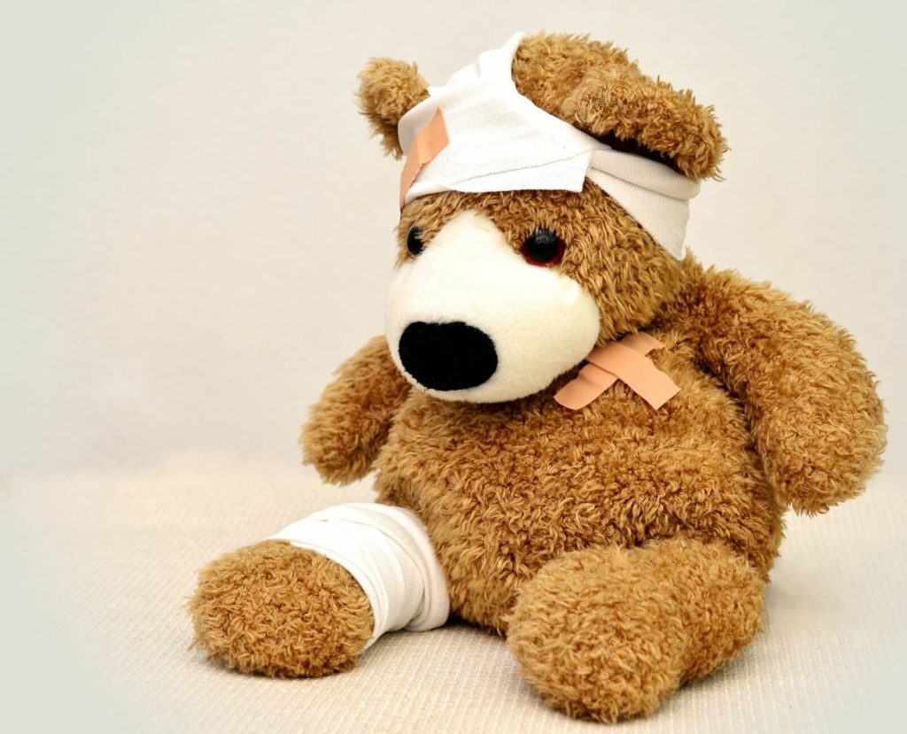 Teddy bear with bandages on it