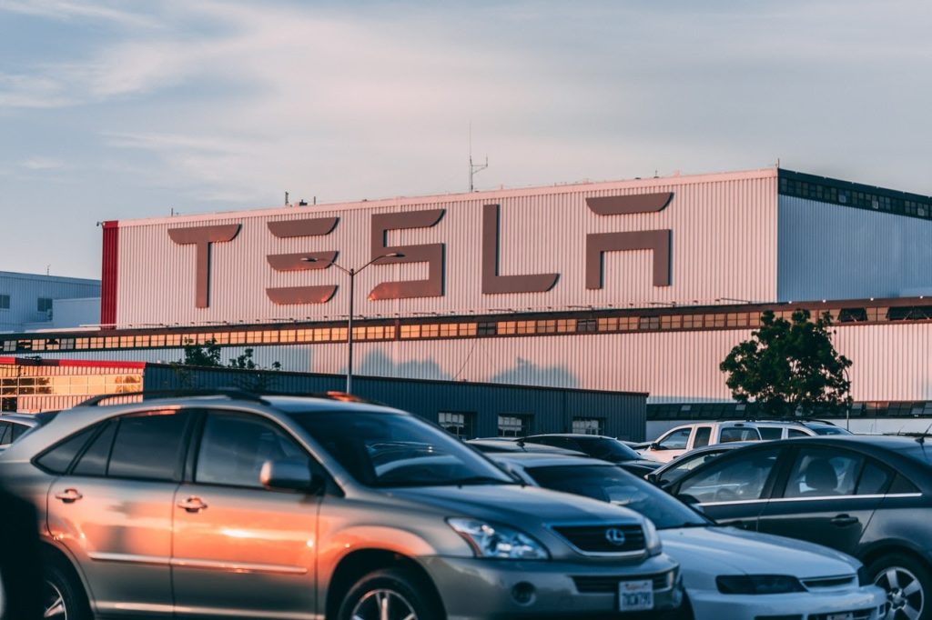 Exterior shot of Tesla dealership with cars in the lot