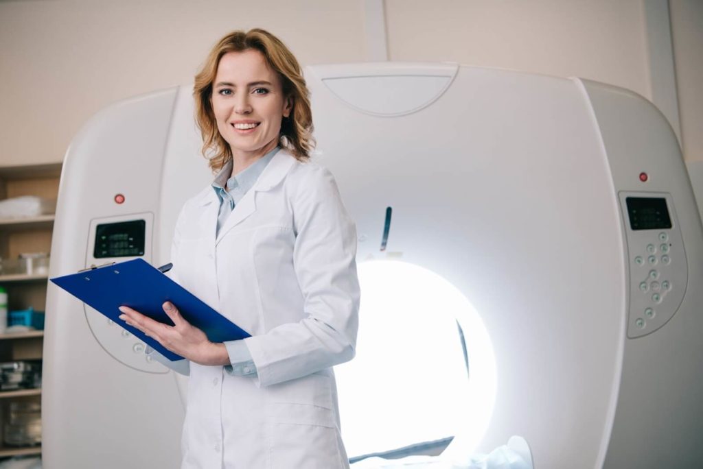 Radiologist standing in front of CRT machine