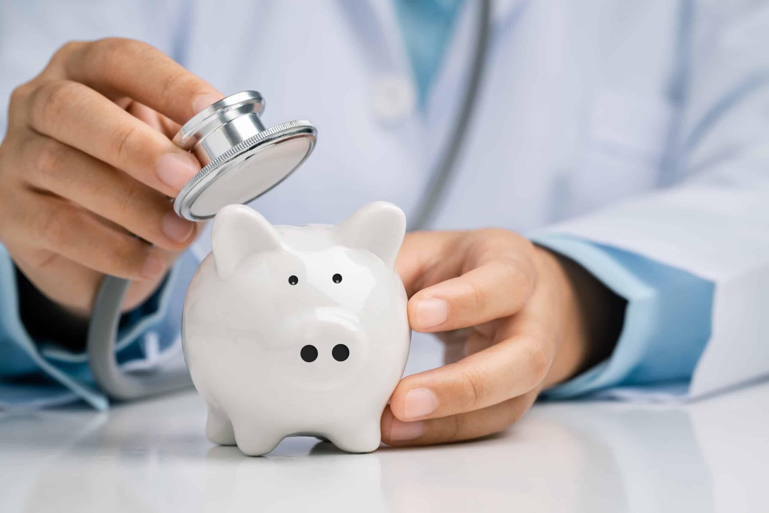 doctor using a stethoscope to check the piggy bank financial check-up concept check financial sustainability of financial status at frandsen